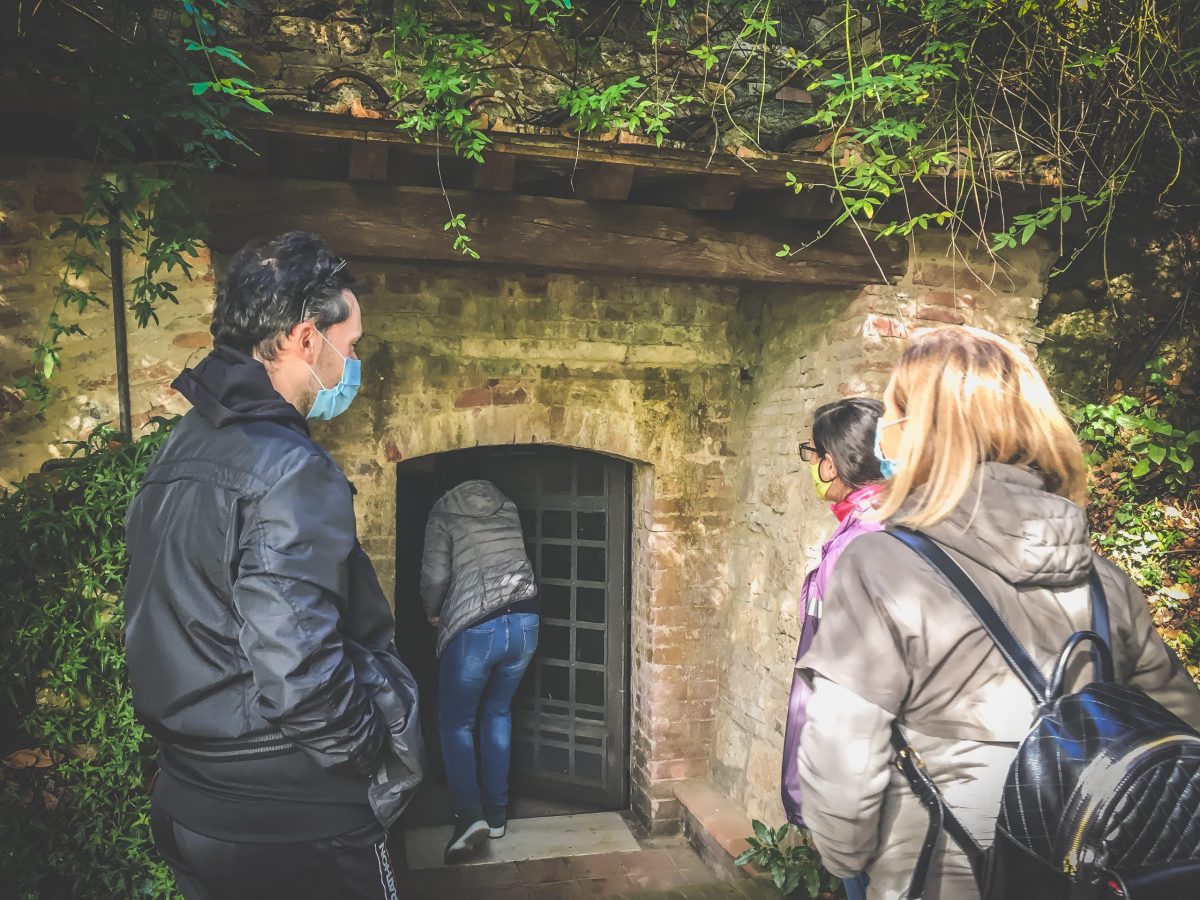 Visitors at the entrance to the Colle Santa Mustiola wine cellar in Chiusi