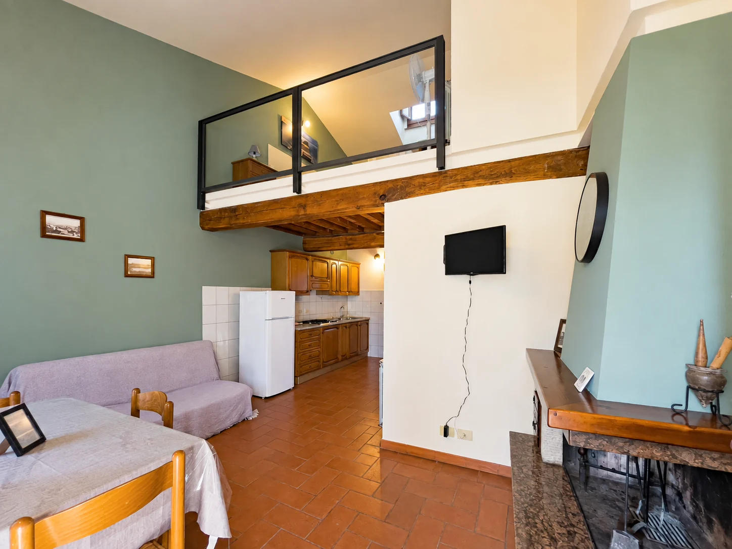 Soggiorno con cucina e soppalco dell’appartamento Il Padrone a Paciano
