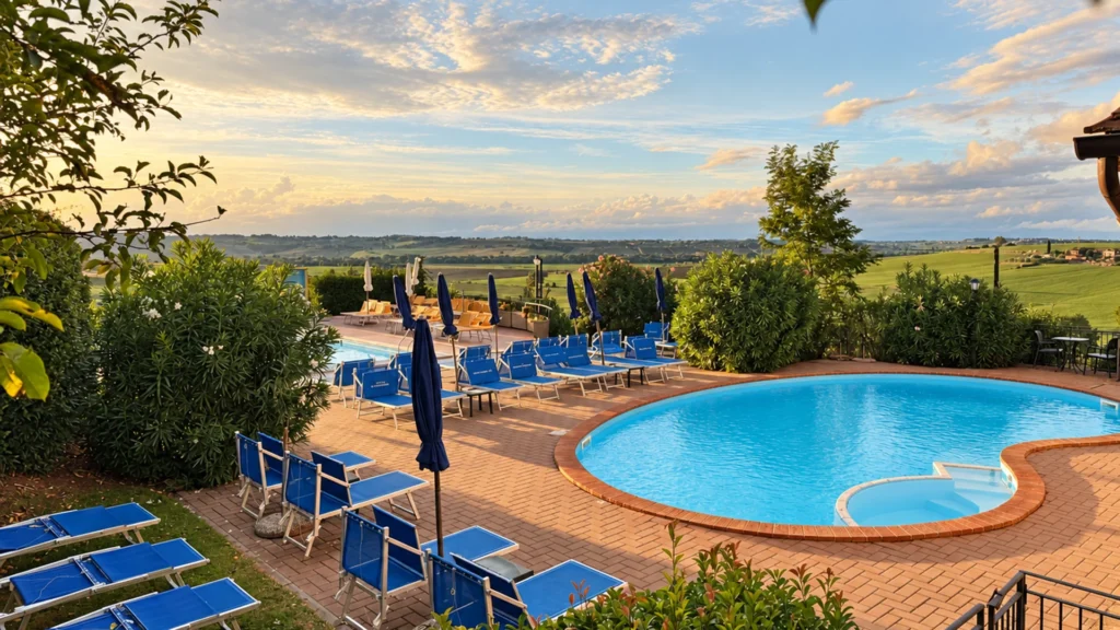 Piscines de Tenuta Badia avec transats bleus et vue sur la campagne ombrienne